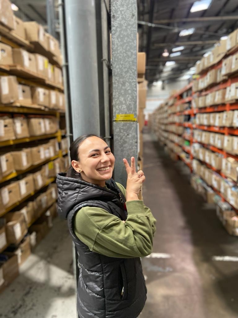 Woman smiling in a warehouse